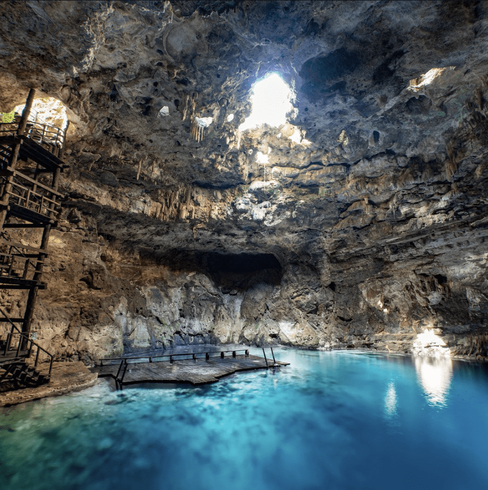 Underground cenote with crystal clear blue water